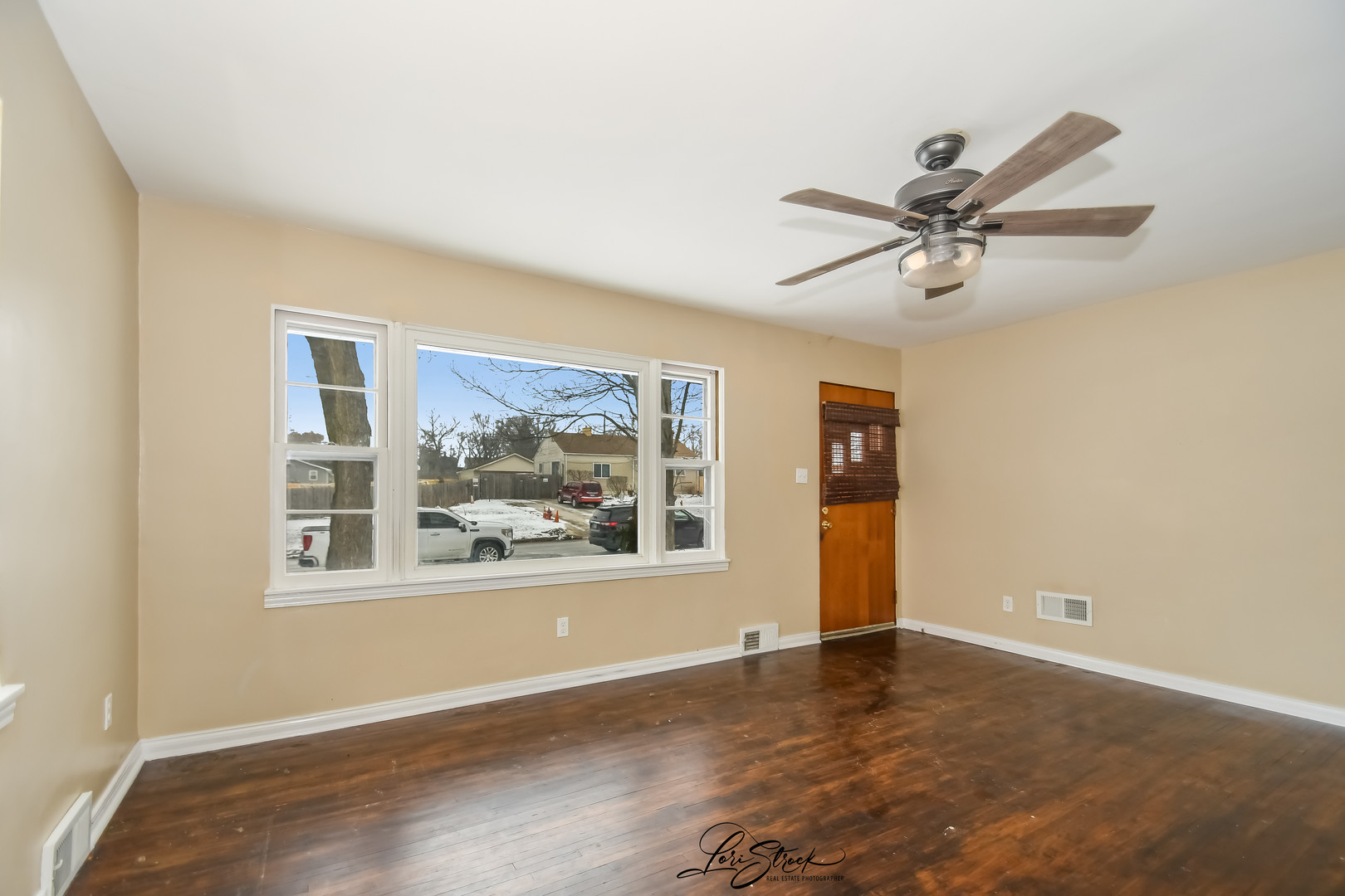 1009 Helen Avenue Joliet, IL 60433 - Photo 7 of 23 a view of an empty room with wooden floor and a ceiling fan