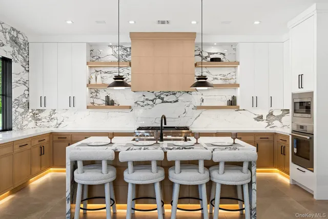 a kitchen with a dining table chairs sink and stove