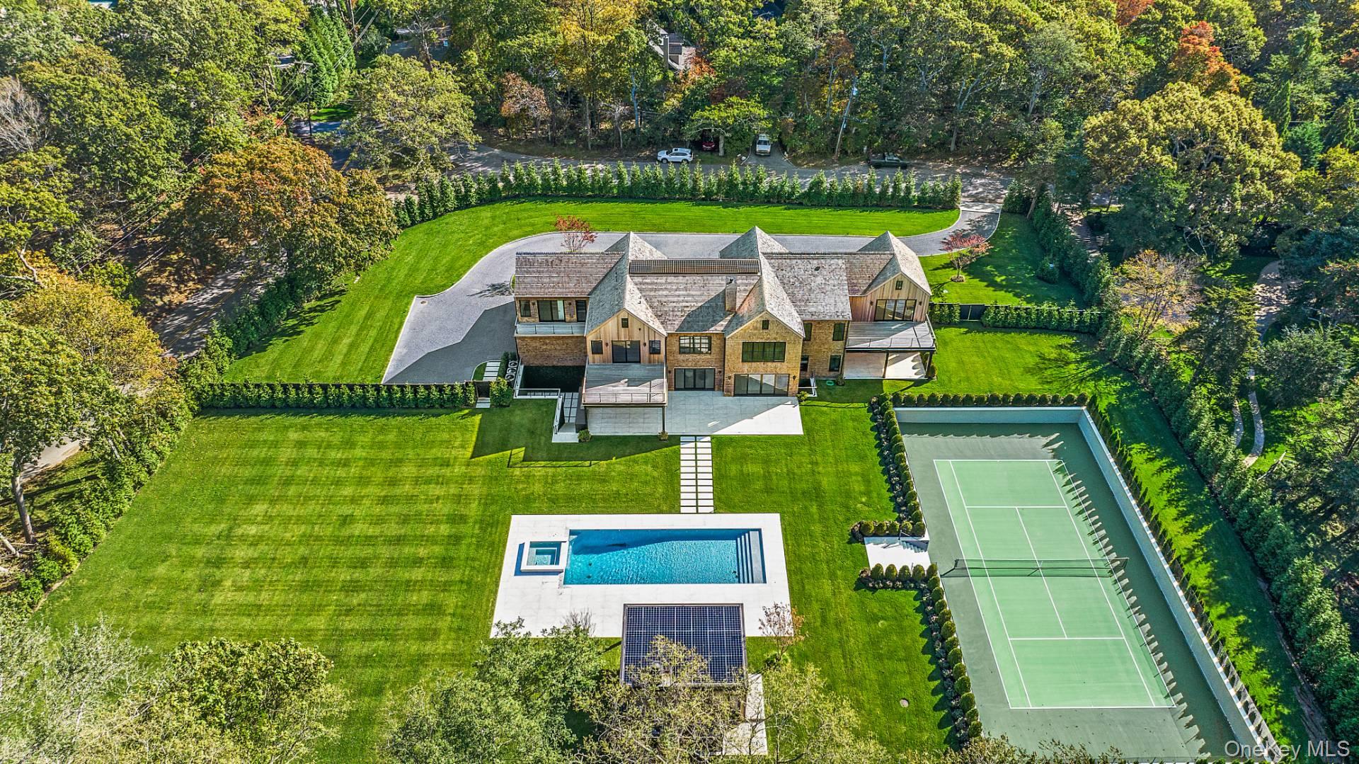 150 Edge Of Woods Road Southampton, NY 11968 - Photo 2 of 47 an aerial view of a house with a garden