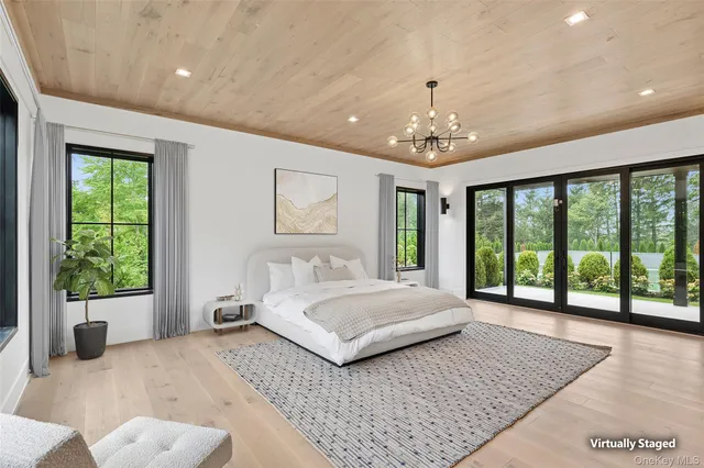 a spacious bedroom with a large bed and a large window