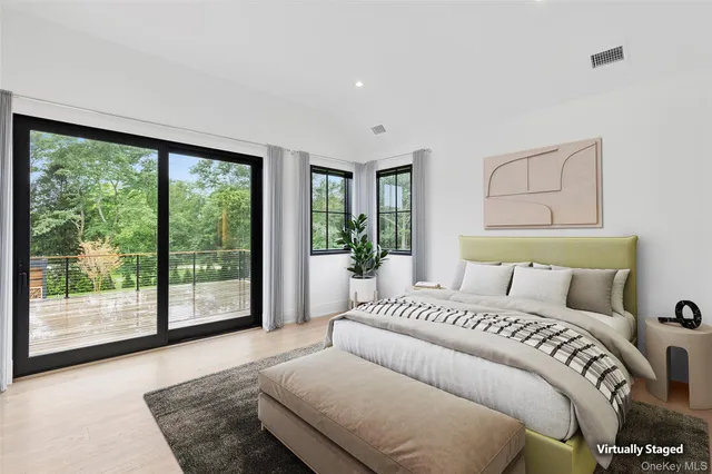 a bedroom with a large bed and a large window