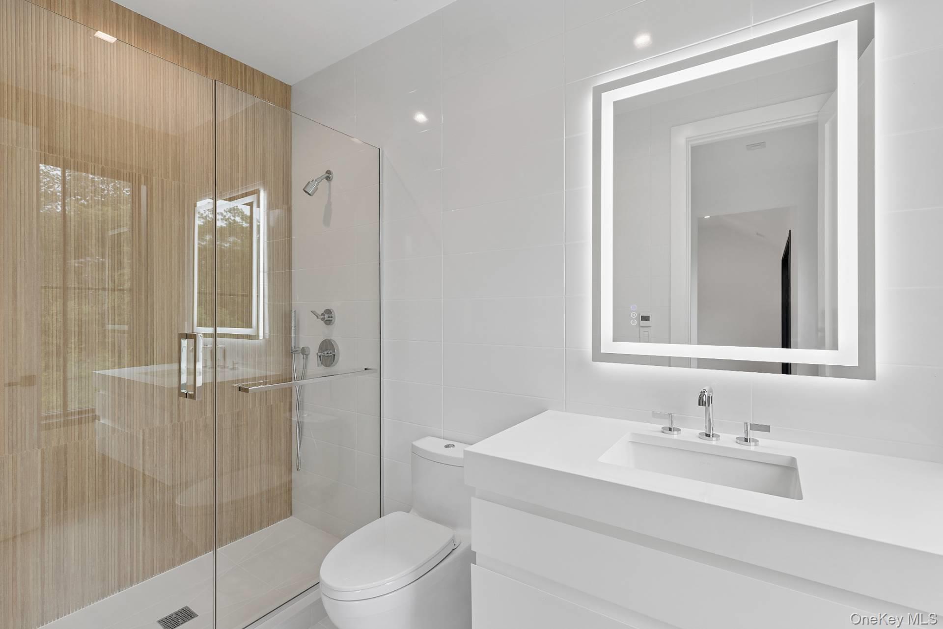 150 Edge Of Woods Road Southampton, NY 11968 - Photo 32 of 47 a bathroom with a sink a toilet and shower