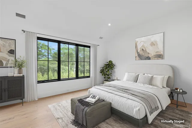 a bedroom with a large bed and a large window