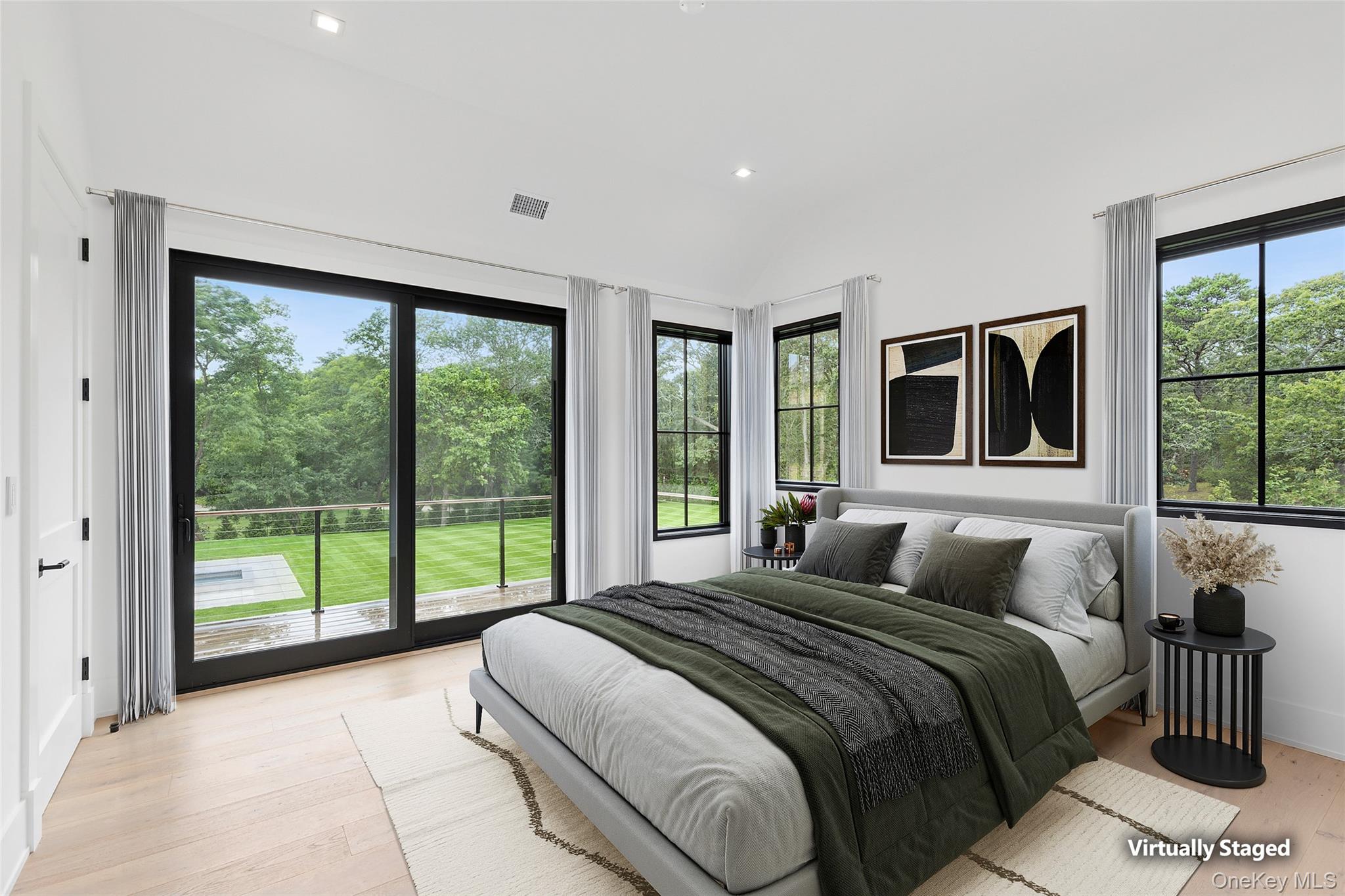 150 Edge Of Woods Road Southampton, NY 11968 - Photo 35 of 47 a bedroom with a large bed and a large window