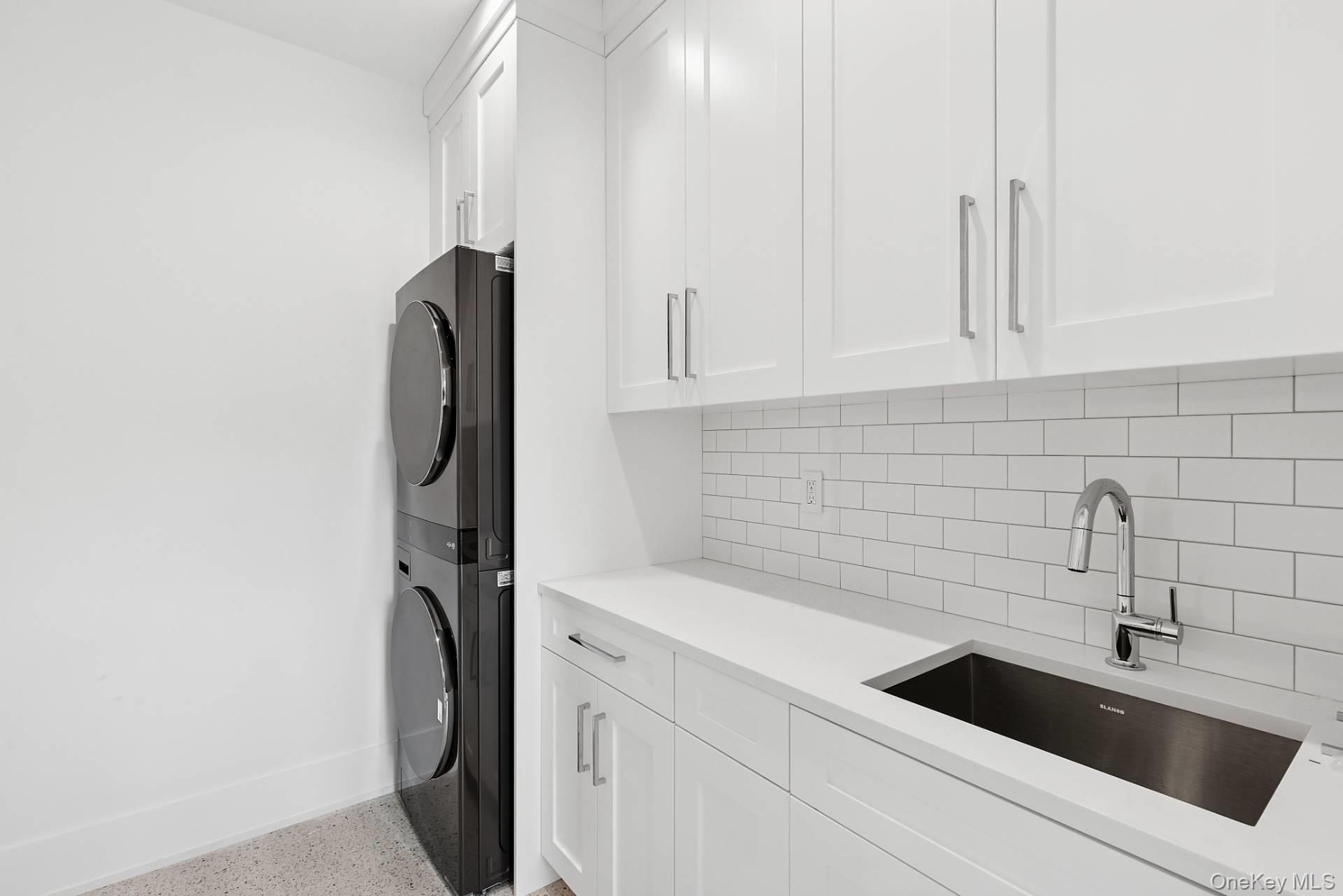 150 Edge Of Woods Road Southampton, NY 11968 - Photo 38 of 47 a kitchen with a sink and cabinets