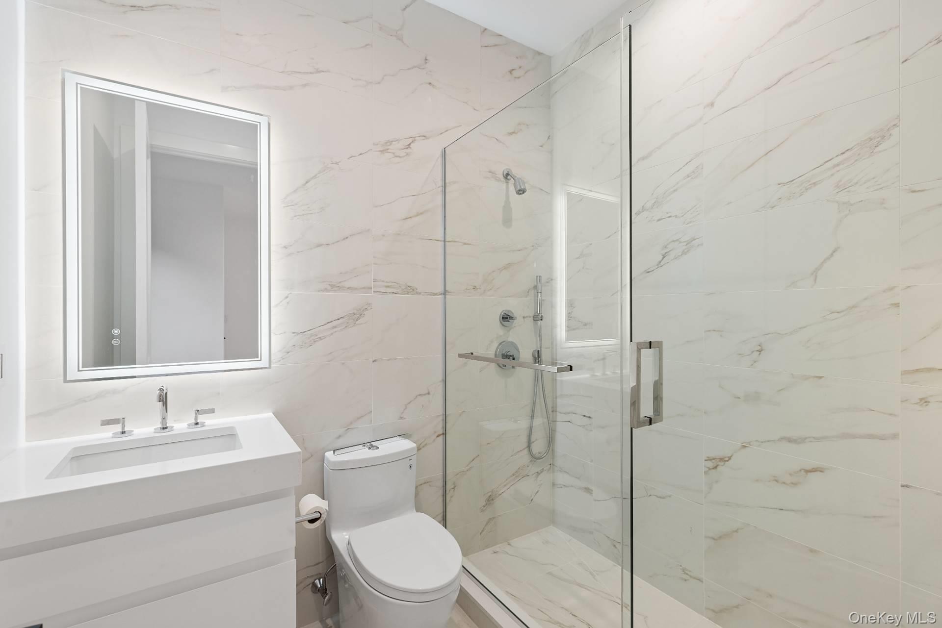 150 Edge Of Woods Road Southampton, NY 11968 - Photo 40 of 47 a bathroom with a toilet a sink a mirror and vanity