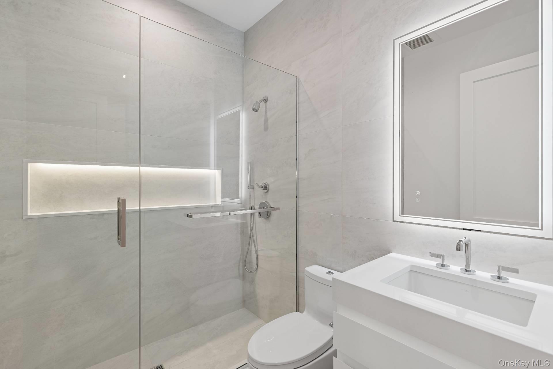 150 Edge Of Woods Road Southampton, NY 11968 - Photo 41 of 47 a bathroom with a toilet sink vanity granite and shower