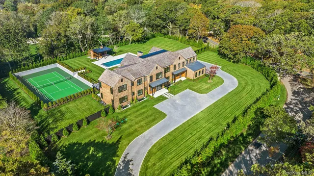 an aerial view of a house with a yard