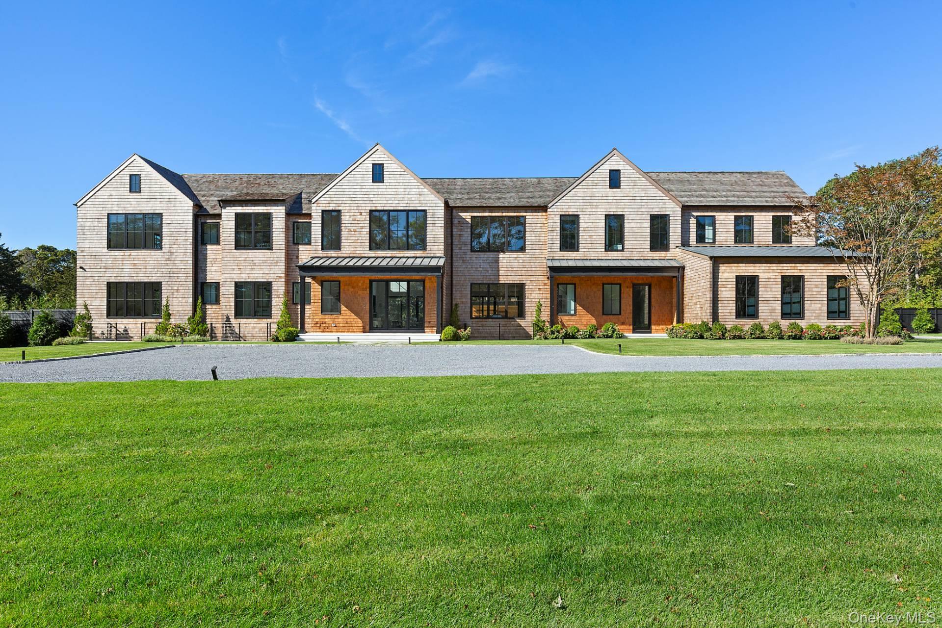 150 Edge Of Woods Road Southampton, NY 11968 - Photo 5 of 47 a front view of a house with a yard and trees