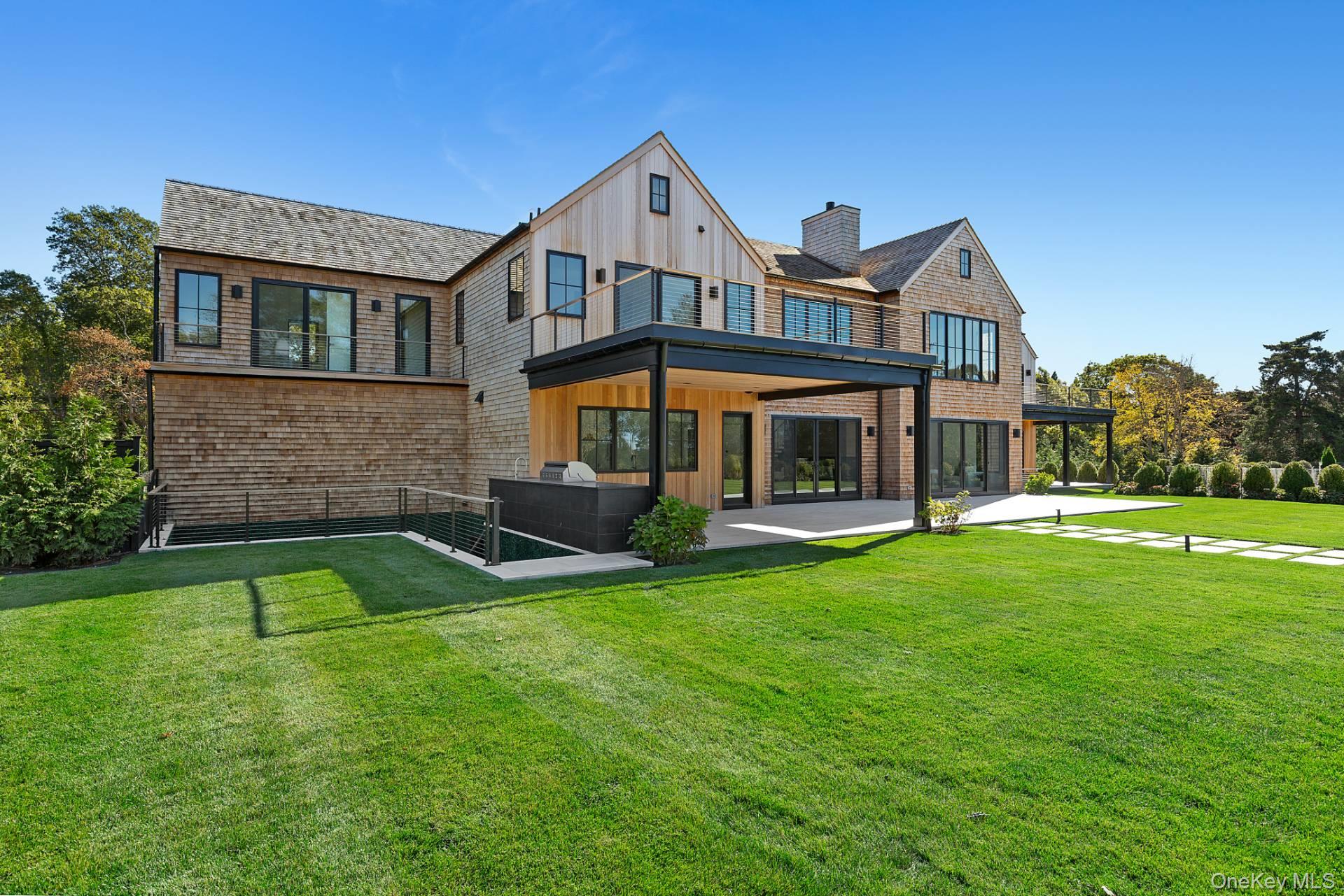 150 Edge Of Woods Road Southampton, NY 11968 - Photo 7 of 47 a front view of a house with a yard