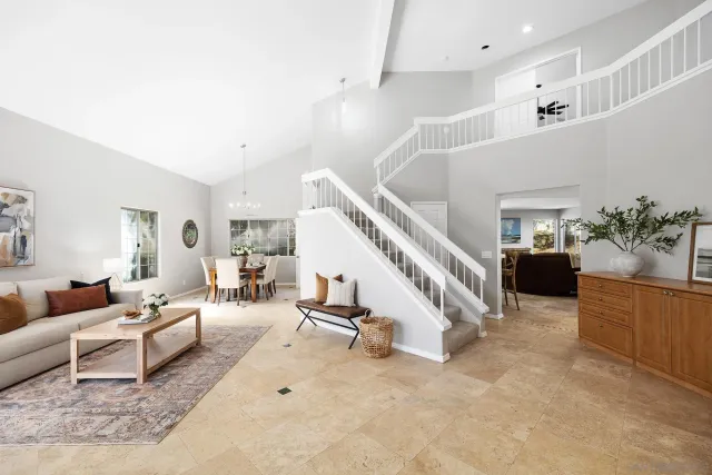 a living room with furniture and stairs