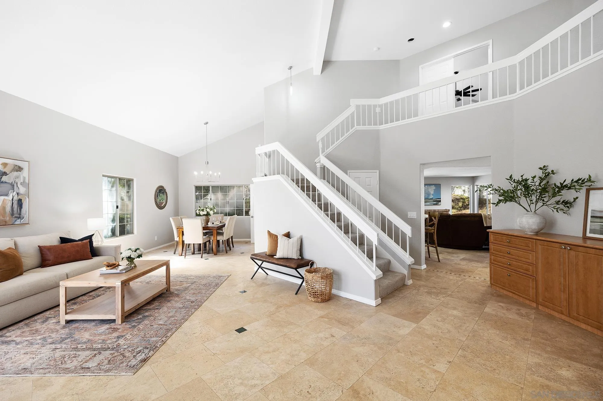 a living room with furniture and stairs