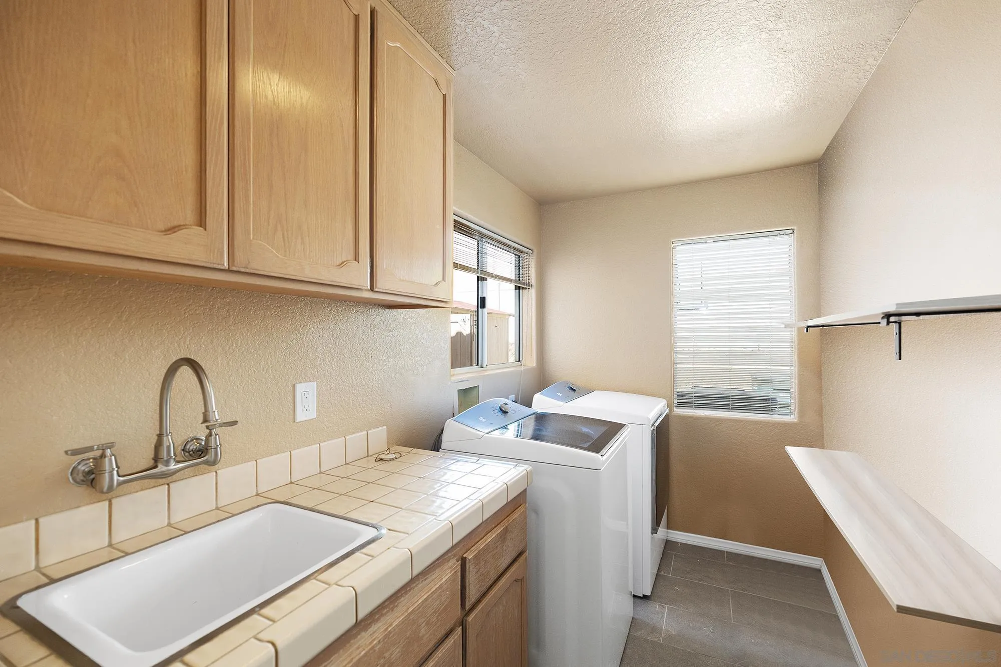 13958 Carriage Road Poway, CA 92064 - Photo 17 of 35 a kitchen with a sink cabinets and window