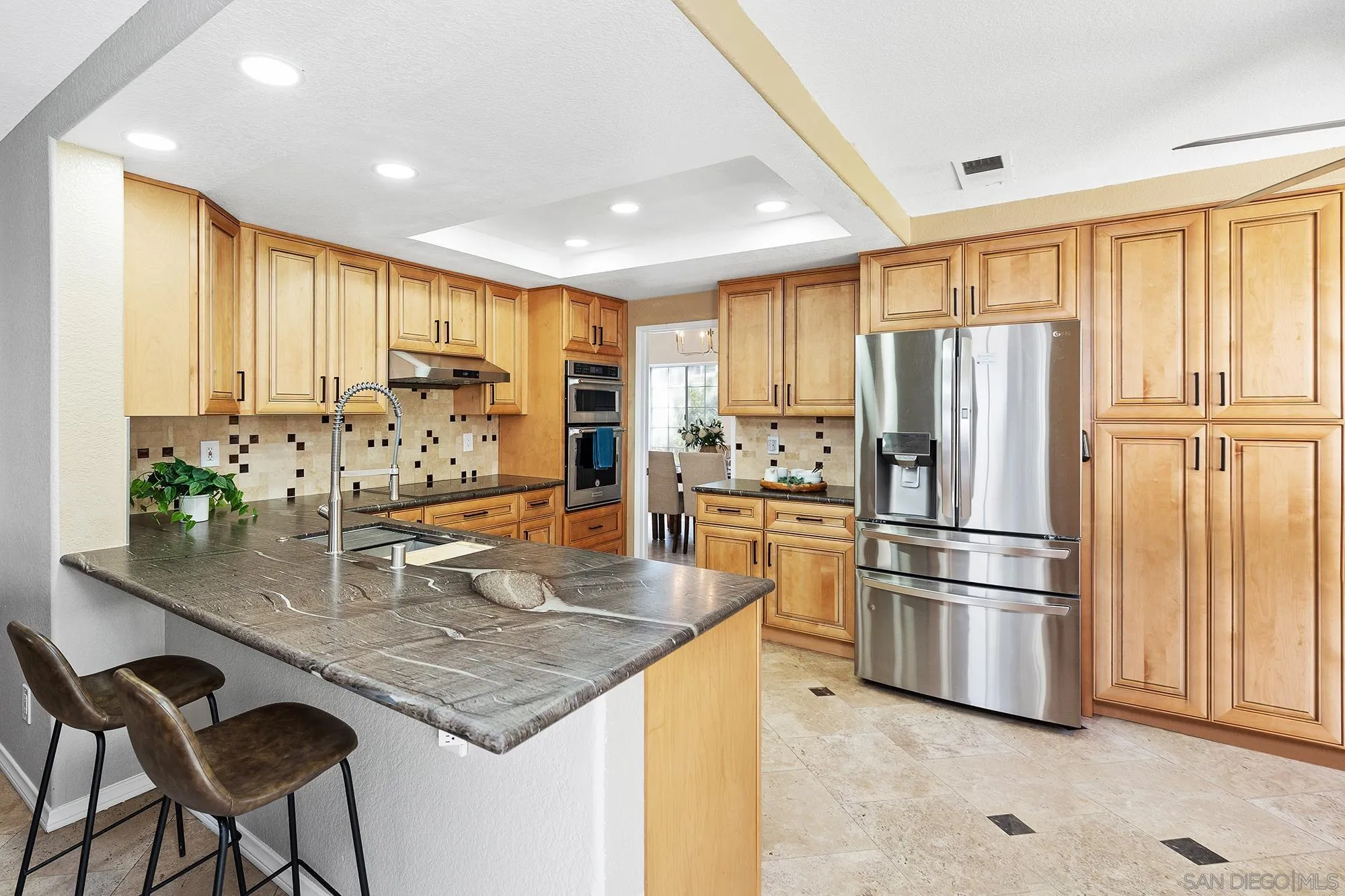 13958 Carriage Road Poway, CA 92064 - Photo 3 of 35 a kitchen with stainless steel appliances granite countertop a refrigerator a stove and white cabinets with wooden floor
