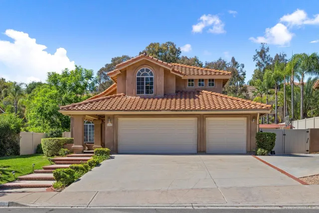 an aerial view of a house with a swimming pool
