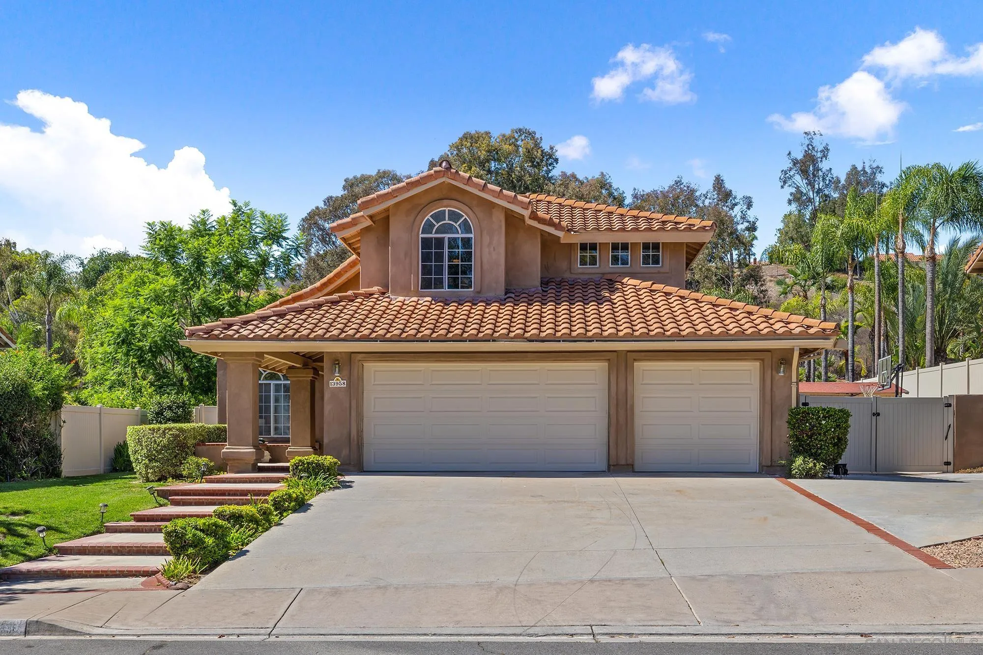 13958 Carriage Road Poway, CA 92064 - Photo 31 of 35 a front view of a house with a yard and garage