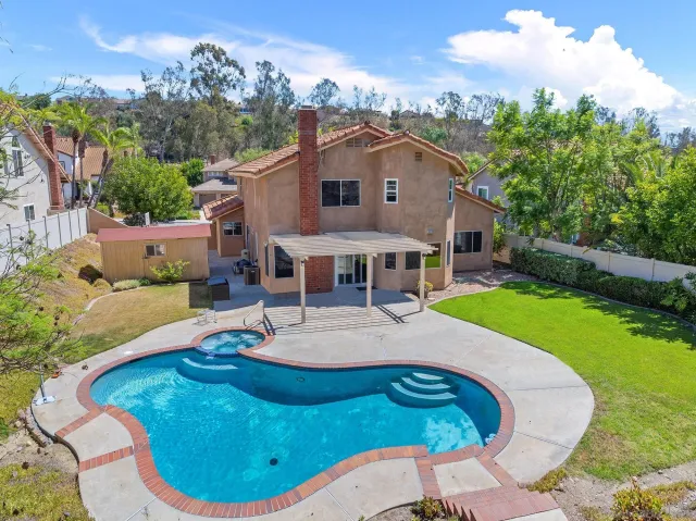 a view of a house with backyard porch and sitting area