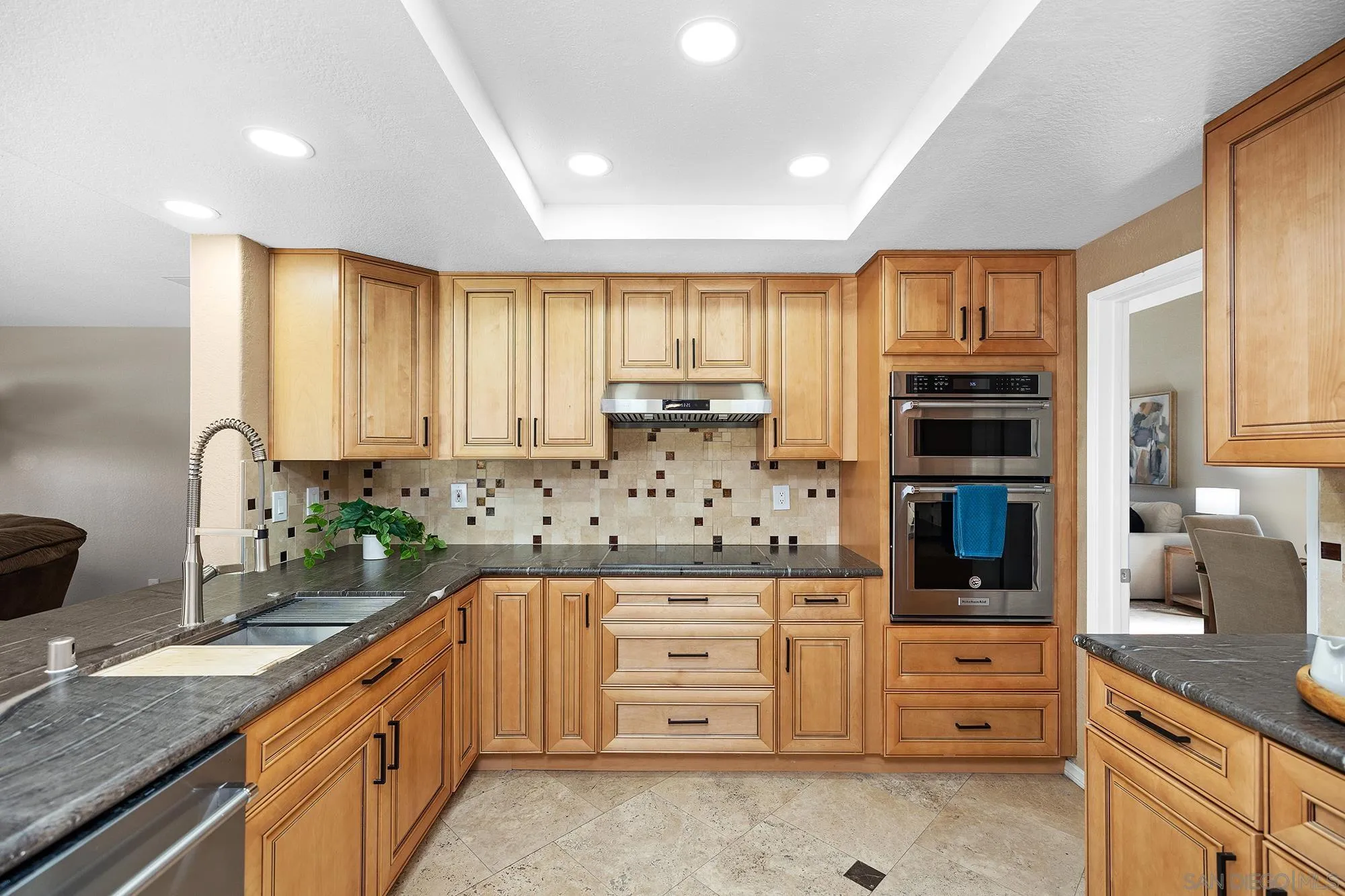 13958 Carriage Road Poway, CA 92064 - Photo 4 of 35 a kitchen with granite countertop a stove a sink and a refrigerator