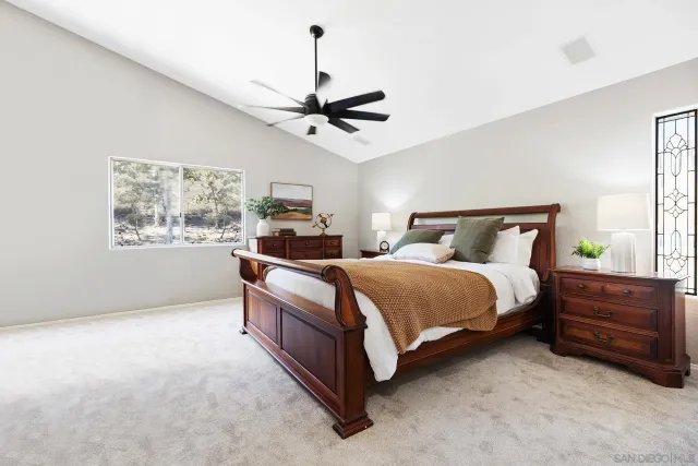 a bedroom with a bed dresser and window