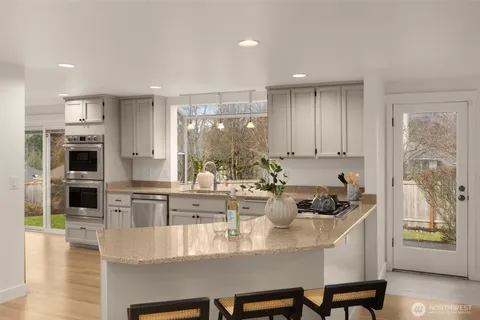 a kitchen with a dining table chairs and stove