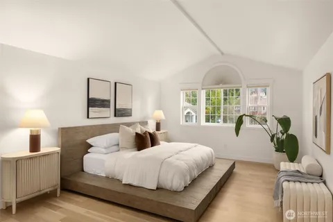 a bedroom with a large bed and a window