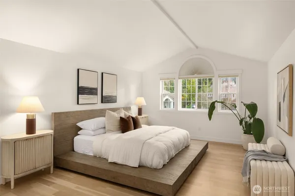 a bedroom with a large bed and a window