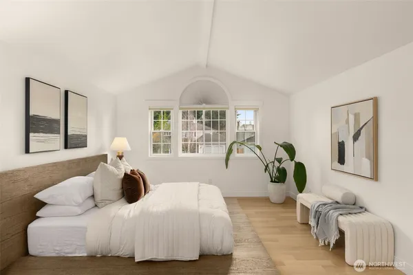 a bedroom with a bed and a large window