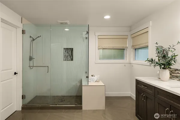 a bathroom with a sink a shower and a mirror