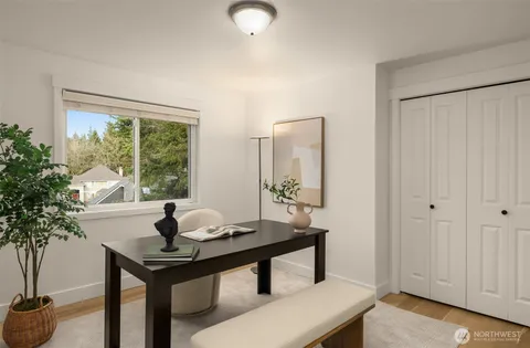 a view of a workspace room with a table and chair in a room