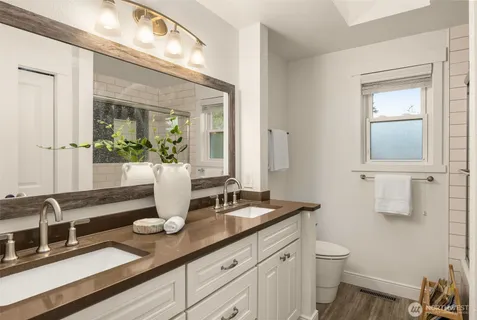 a bathroom with a double vanity sink and mirror