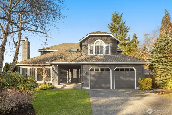 a front view of a house with a garden and plants