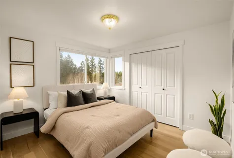 a bedroom with a bed and a couch