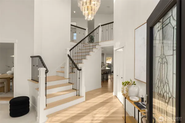 a view of entryway and hall with wooden floor