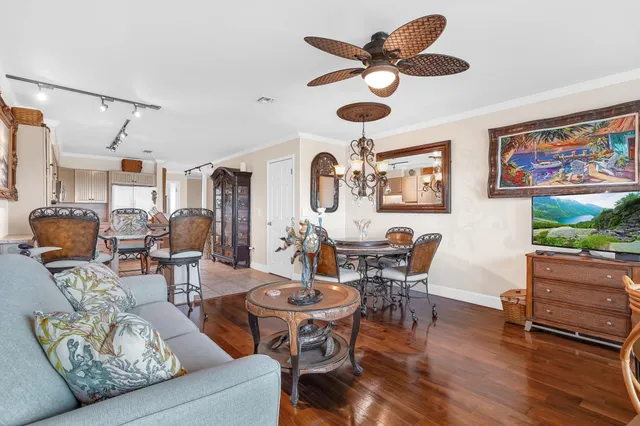 a living room with furniture a flat screen tv and a window