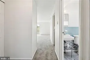 a view of a bathroom from a hallway
