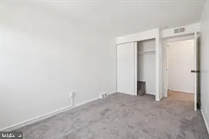 an empty room with closet area