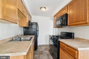 a kitchen that has a sink and a stove top oven