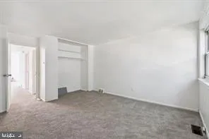 an empty room with closet area