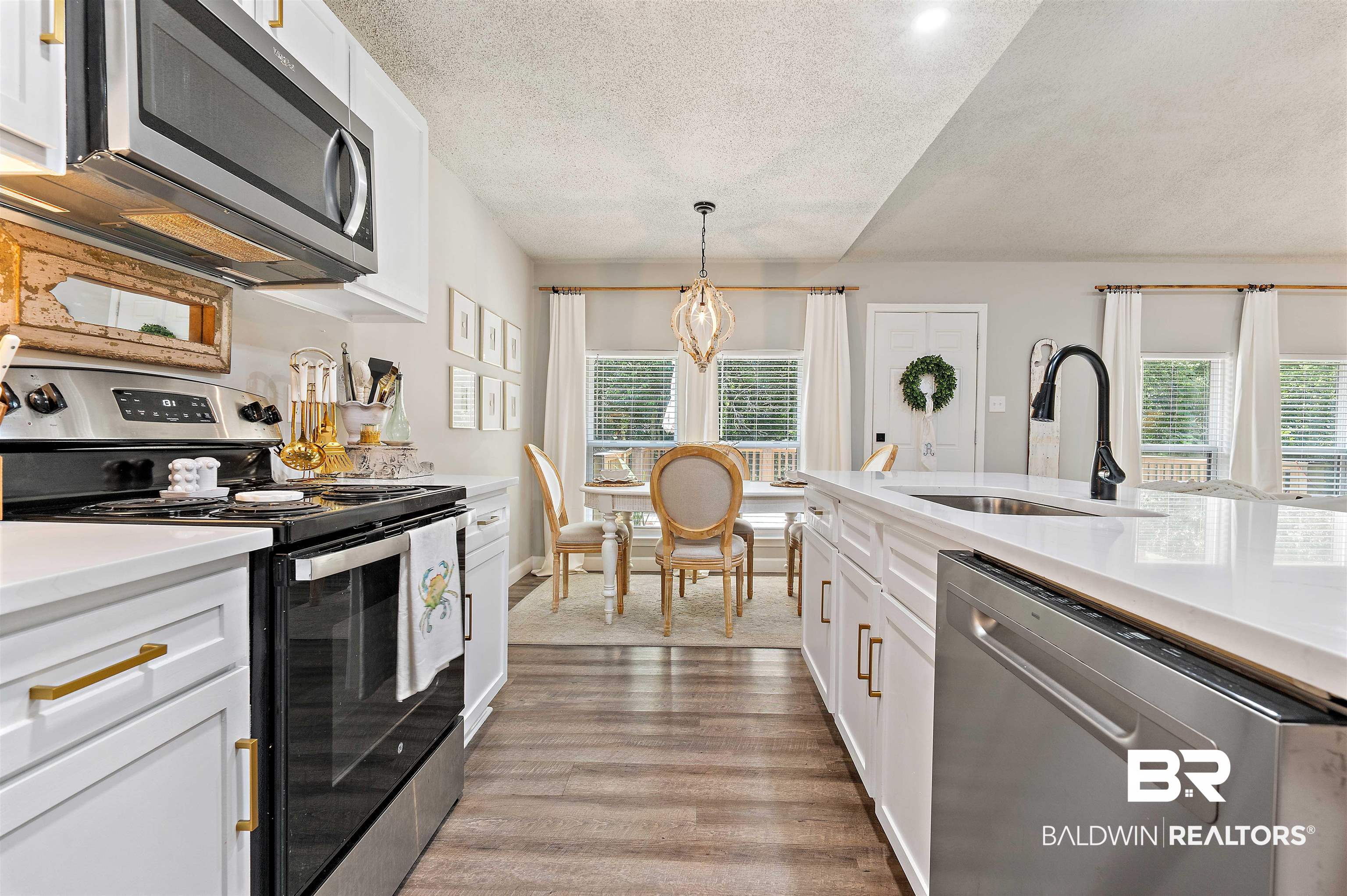 4682 Opal Drive Mobile, AL 36619 - Photo 11 of 27 Kitchen featuring a healthy amount of sunlight, appliances with stainless steel finishes, sink, and light hardwood / wood-style floors