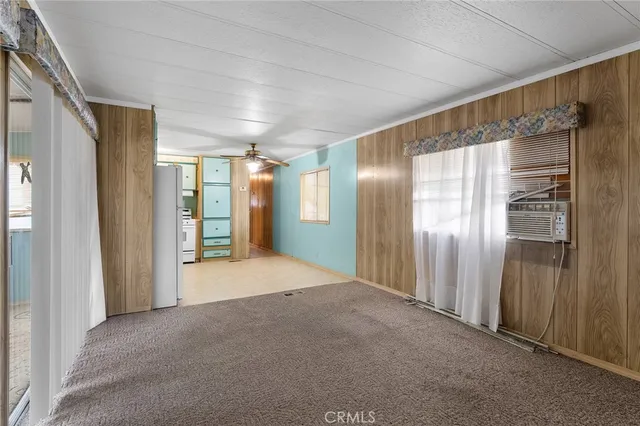 a kitchen with cabinets stainless steel appliances and a window