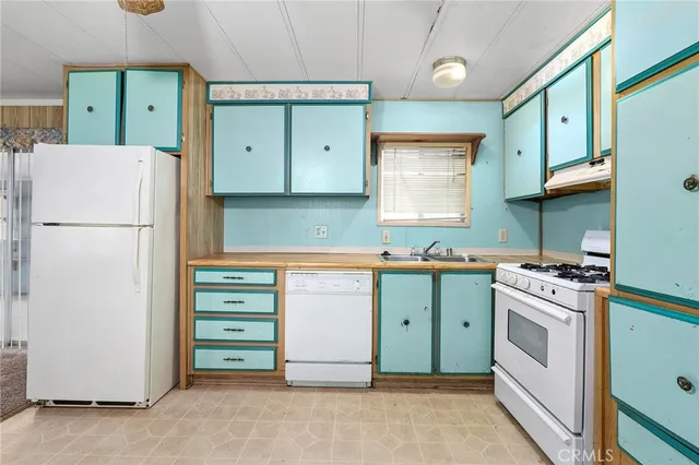 a kitchen with cabinets a refrigerator and a stove