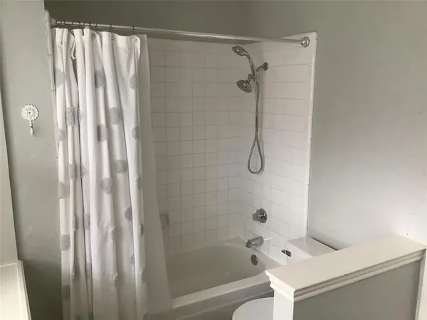 a bathroom with a shower and a toilet