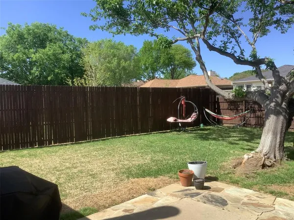 a backyard of a house with barbeque oven