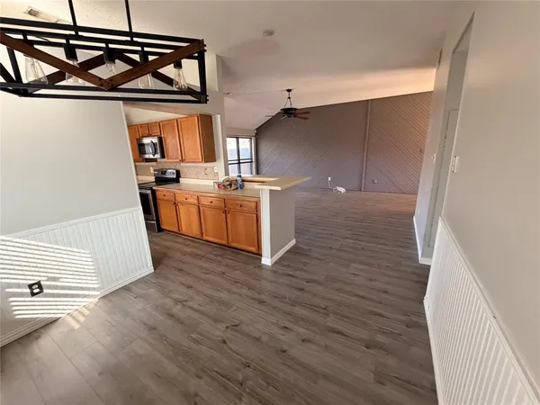 a view of a kitchen with wooden floor