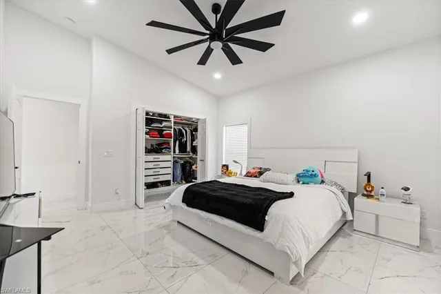a bedroom with a bed and a book shelf
