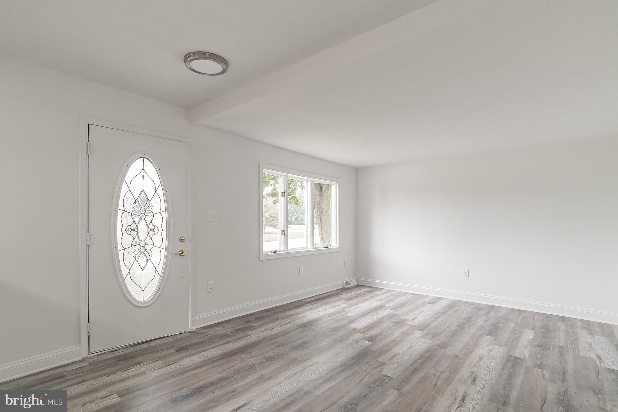 345 Pine Grove Road Hanover, PA 17331 - Photo 5 of 37 an empty room with window mirror and windows