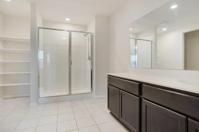 a bathroom with a shower and a sink