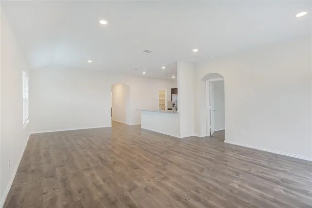 a view of a livingroom with a dishwasher and wooden floor