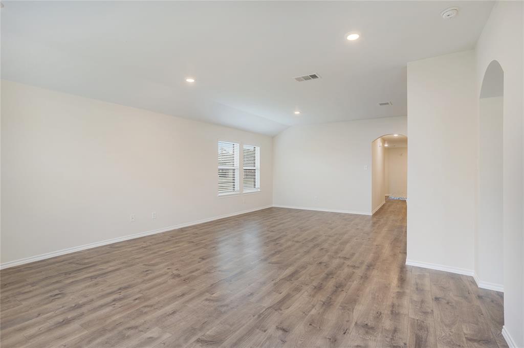 2328 Stefani Street Anna, TX 75409 - Photo 9 of 23 an empty room with wooden floor and windows