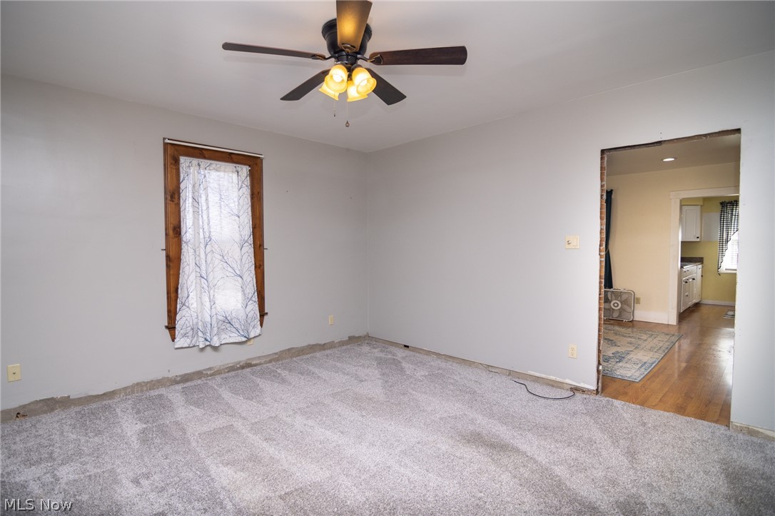 53341 Key Bellaire Road Bellaire, OH 43906 - Photo 13 of 48 Unfurnished room featuring light colored carpet and a ceiling fan